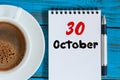 October 30th. Day 30 of month, calendar and hot coffee cup at translator or interpreter workplace background. Autumn