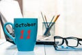 October 11th. Day 11 of month, calendar on morning hot drink cup at architect workplace background. Autumn time. Empty