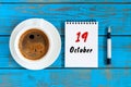 October 19th. Day 19 of october month, calendar on workbook with coffee cup at student workplace background. Autumn time