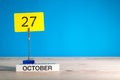 October 27th. Day 27 of october month, calendar on workplace with blue background. Autumn time. Empty space for text