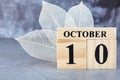 October 10th. Hello October, Cube wooden calendar showing date on 10 October.