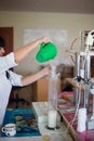 October 14, 2014.Ukraine.Kyiv. Caucasian middle-aged woman in a white coat in the chemical laboratory. A specialist at work, on