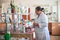 October 14, 2014.Ukraine.Kyiv. Caucasian middle-aged woman in a white coat in the chemical laboratory. A specialist at work, on