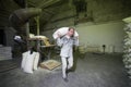 14 october 2014. Ukraine.Kyiv.The theme is a working factory. A Caucasian man carries heavy bags of finished products in an old