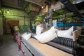 14 october 2014.Ukraine.Kyiv. The woman of average years in a white dressing gown works on a conveyor at factory of times of the