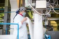 14 october 2014.Ukraine.Kyiv. The woman of average years in a white dressing gown works on a conveyor at factory of times of the