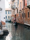 October 31, 2022 - Venice, Italy: People enjoying gondola ride through a canal in Venice