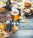 Octoberfest beer and snacks set on dark scorched wooden background Royalty Free Stock Photo