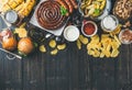 Octoberfest beer and snacks variety on dark scorched wooden background