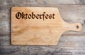 Octoberfest sign on cutting board, copy space, wooden background