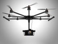 Octocopter carrying DSLR camera on gray background