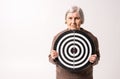 Octogenarian old lady holding target in her wrinkled hands Royalty Free Stock Photo