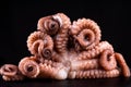Octopus on a black background with greens. Fish food. Seafood. Delicious sea food Royalty Free Stock Photo