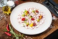 Octopus carpaccio. Spinach cream, cherry tomatoes. Delicious healthy Italian traditional food closeup served for lunch