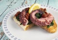 Octopus cooked at low temperature with black cabbage and toast.