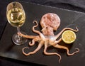 Octopus holds wine with lemon Royalty Free Stock Photo