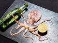 Octopus holds wine with lemon Royalty Free Stock Photo