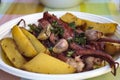 Octopus Lagareiro. Roasted octopus with potatoes, garlic and olive oil. Portuguese cuisine Royalty Free Stock Photo