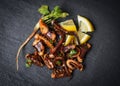 Octopus salad with lemon herbs and spices on dark background top view - Tentacles squid grilled appetizer food hot and spicy