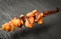 Octopus in skewer sticks on dark background - Tentacles squid grilled appetizer food hot and spicy in the restaurant