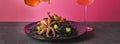 Octopus tentacles baked in garlic sauce and black pasta with cuttlefish ink. Luxury restaurant food. Seafood. Royalty Free Stock Photo