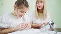 an oculist teaches girl to put on orthokeratological contact lenses