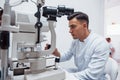 Oculist tests vision of patient by using special modern machine