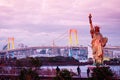 Odaiba Rainbow bridge and statue of Liberty with Tokyo bay view at night Royalty Free Stock Photo