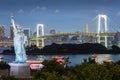 Odaiba Statue of Liberty with rainbow bridge and Tokyo tower in evening Royalty Free Stock Photo