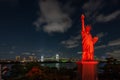 Odaiba Statue of Liberty Replica surrounded by buildings and lights during the night in Japan