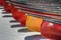 Odd Man Out - a yellow canoe sandwiched between red canoes lined up on the shore at Cameron Lake, Waterton, Alberta, Canada