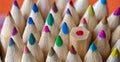 Odd one out. Coloured pencil tips and one upside down. Royalty Free Stock Photo