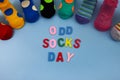 Odd Socks Day. Day lost socks, lonely socks on blue background.