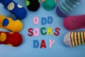 Odd Socks Day. Day lost socks, lonely socks on blue background.