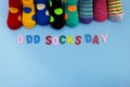 Odd Socks Day. Day lost socks, lonely socks on blue background. Royalty Free Stock Photo