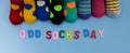 Odd Socks Day. Day lost socks, lonely socks on blue background. Royalty Free Stock Photo