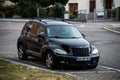 Front view of black Chrysler Cruise parked in the street