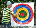 A boy taking an arrow for archery from a homemade target