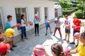 Teenagers, simultaneously throwing the ball in a circle in a sports game, team building