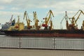 ODESA, UKRAINE - March 04. 2015. Cargo ship with loading cranes in sea port Royalty Free Stock Photo