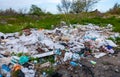 Heaps of plastic trash on the shore of the reservoir. Ecology of nature