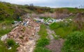 Heaps of plastic trash on the shore of the reservoir. Ecology of nature