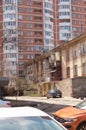 Odessa, Ukraine - 04 16 21: architecture contrast on Arnautskaya street. Old poor shabby barracks in front of modern