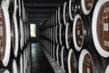 Rows of alcohol barrels in a warehouse of a factory for the production of cognac, whiskey, wine, brandy. Barrel Alcohol Royalty Free Stock Photo