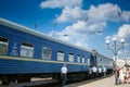 Selective blur on a passengers passing in front of an overnight train of Ukrainian railways (