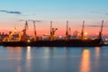 ODESSA, UKRAINE - August 2016: ship unloading at port terminal under full moon in evening with cranes containers and Royalty Free Stock Photo