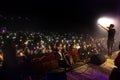 Odessa, Ukraine-circa 2019: large crowd of spectators at concert. Spectators in theater holds lighters and mobile phones at crowd Royalty Free Stock Photo