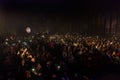 Odessa, Ukraine-circa 2019: large crowd of spectators at concert. Spectators in theater holds lighters and mobile phones at crowd Royalty Free Stock Photo