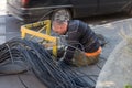 ODESSA, UKRAINE - CIRCA 2019: Maintenance of trunk telephone and Internet cable channels. A young worker lays new cable in an