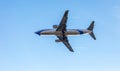 Odessa, Ukraine - CIRKA 2019: Passenger airplane in the air with landing gears lowered before boarding at the airport under